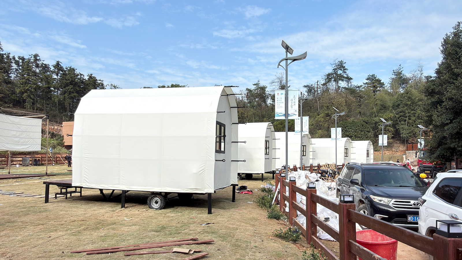 White mobile glamping cabin tents with wheels installed in outdoor resort campsite