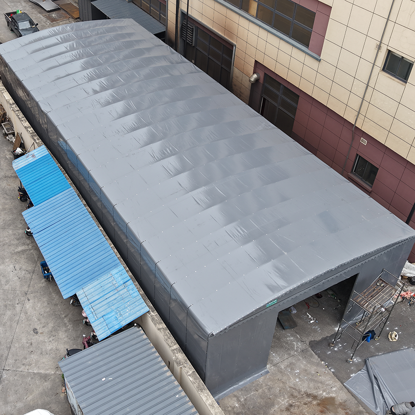 High angle view of fully extended grey motorized retractable warehouse canopy for industrial logistics storage